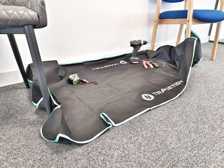 TradeTidy - work mat with tools on a grey floor, chairs in the background