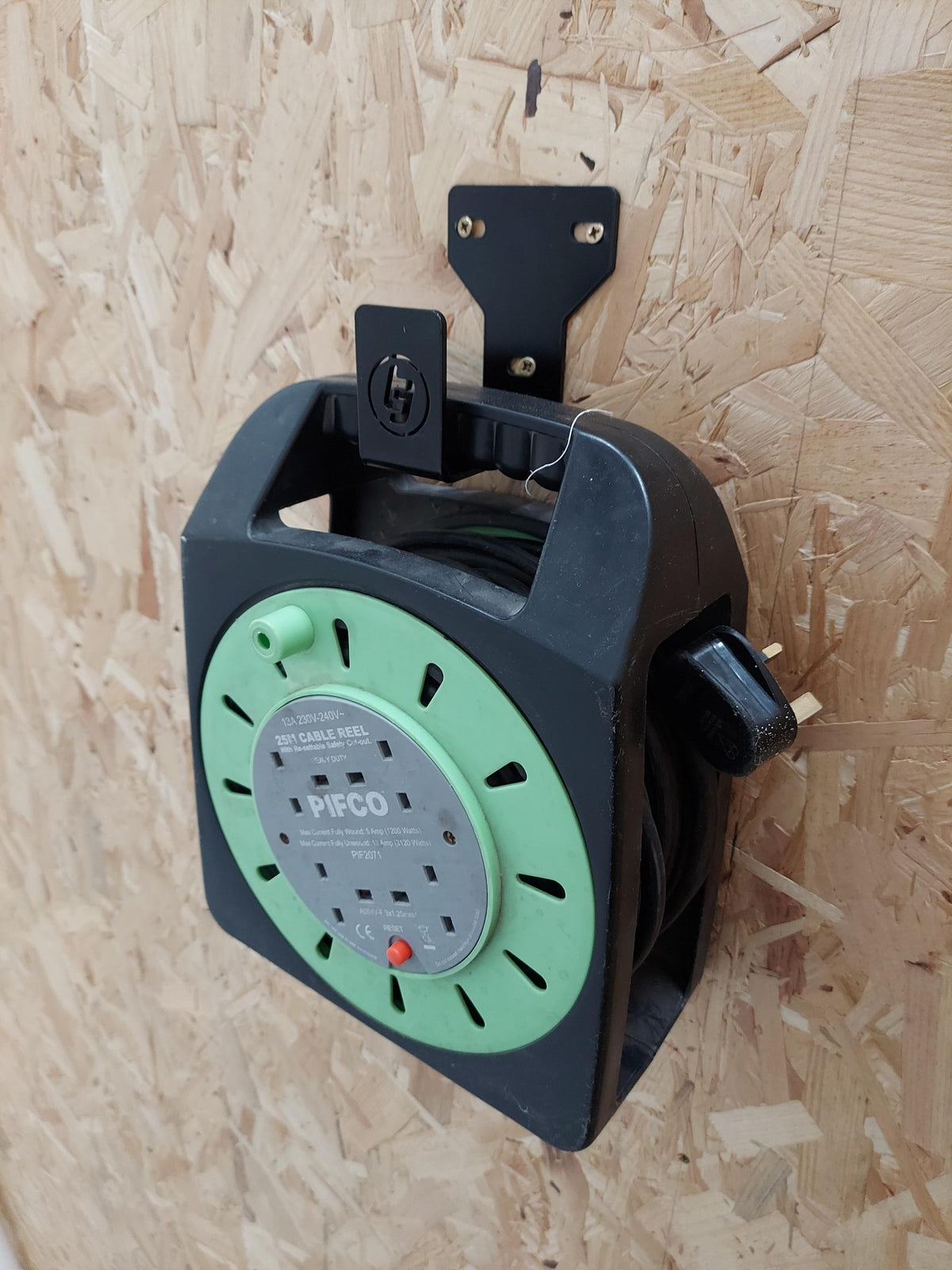 TradeTidy - Extension cord hanging on a Black General Purpose Hook mounted on a wooden wall