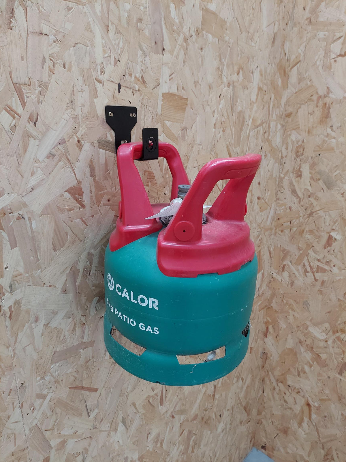 TradeTidy - Gas cartridge hanging on a Black General Purpose Hook mounted on a wooden wall