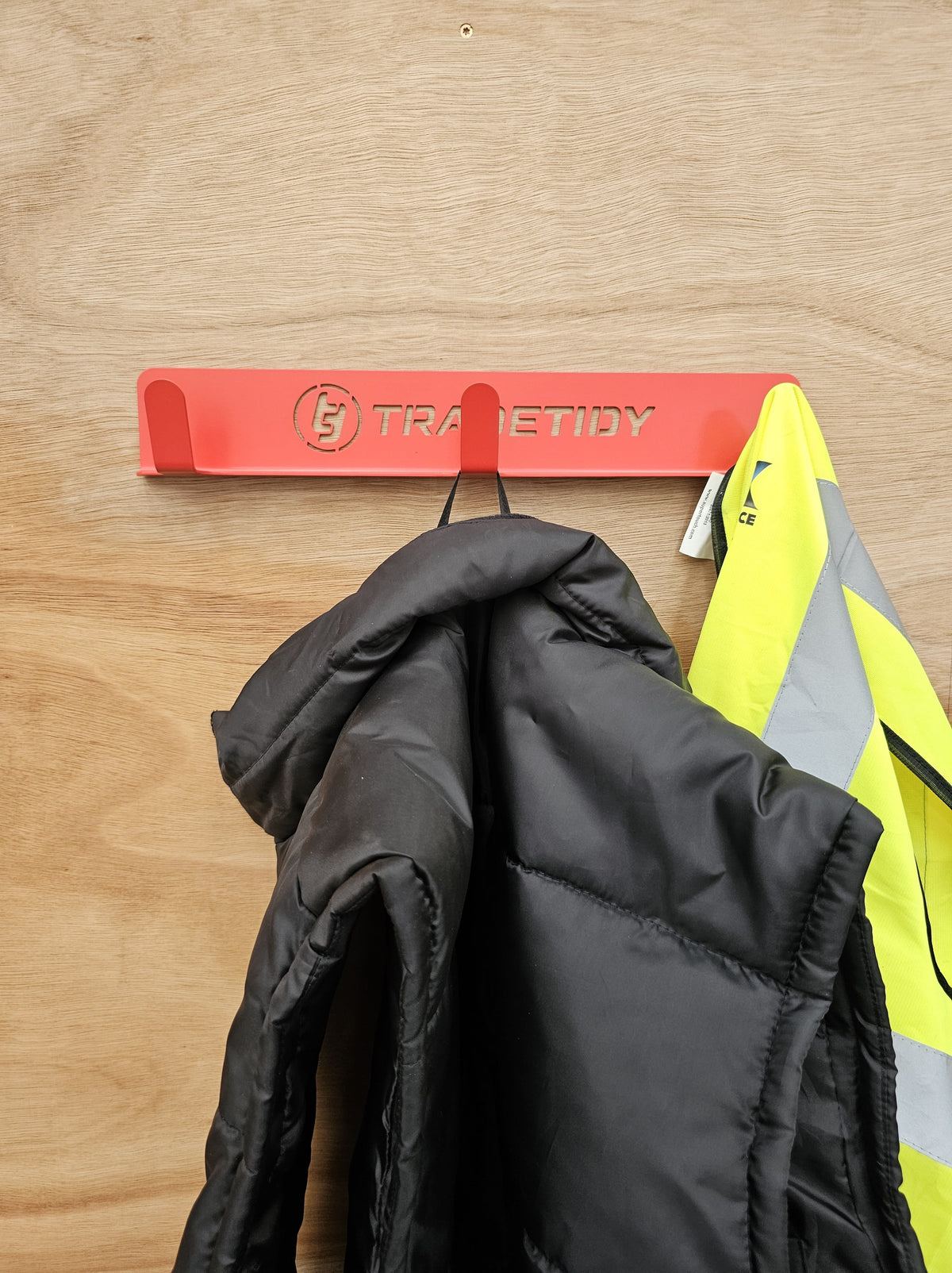 TradeTidy - Red Coat Hanger mounted on a wooden wall with jacket hanging