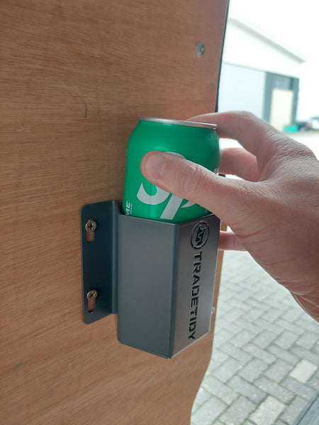 Hand holding a sprite can in a grey TradeTidy can holder with 'TradeTidy' logoon a wooden surface.