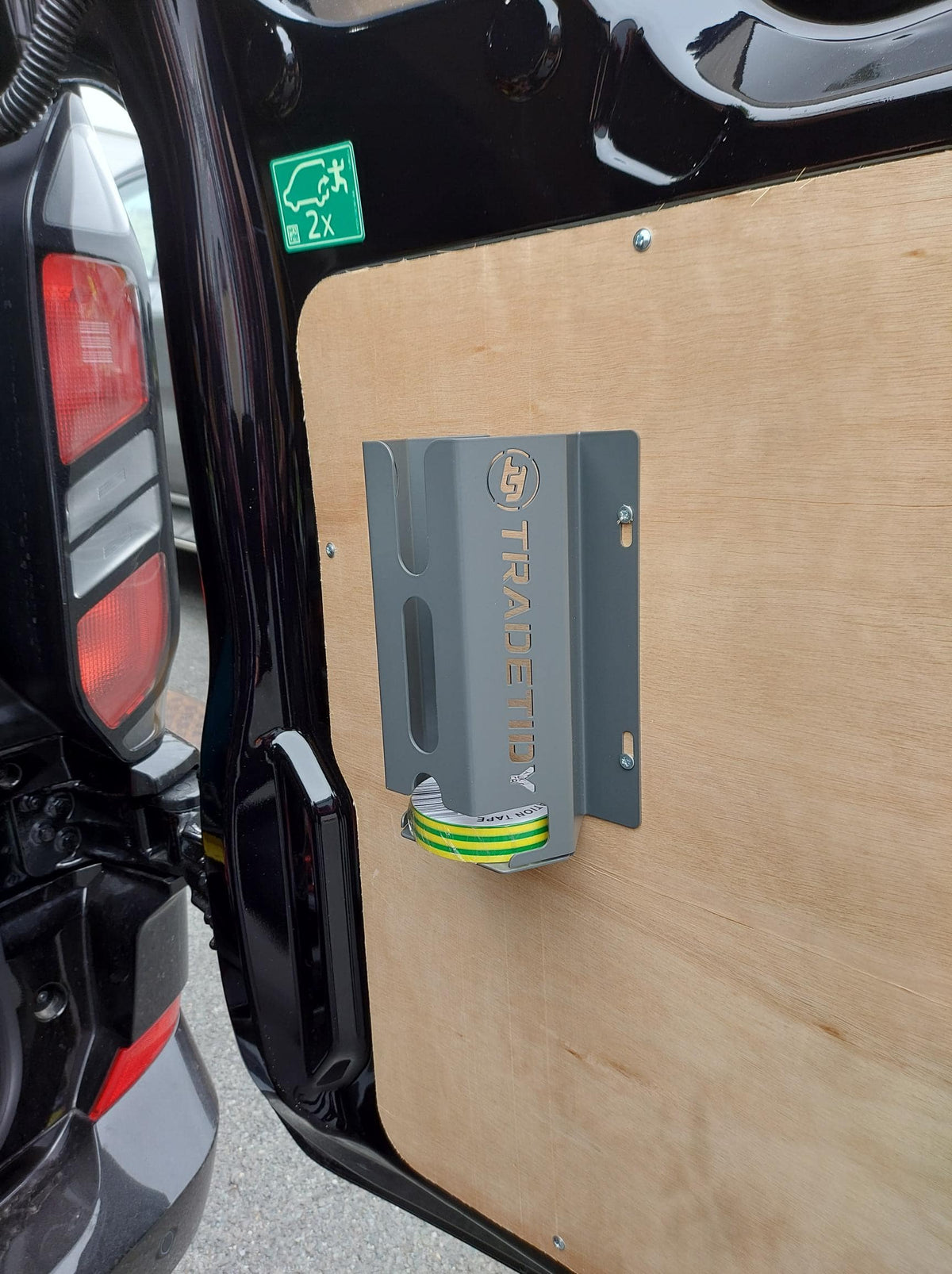 TradeTidy insulation tape holder attached to a vehicle's door.