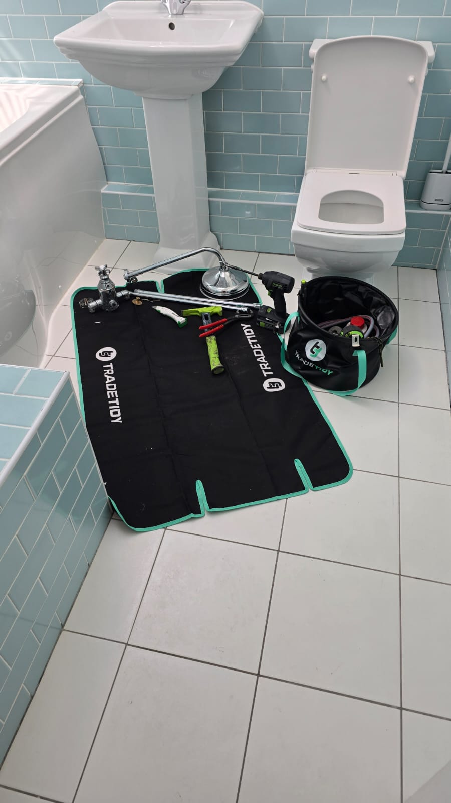 Plumber's equipment on a work TradeTidy mat in a bathroom setting