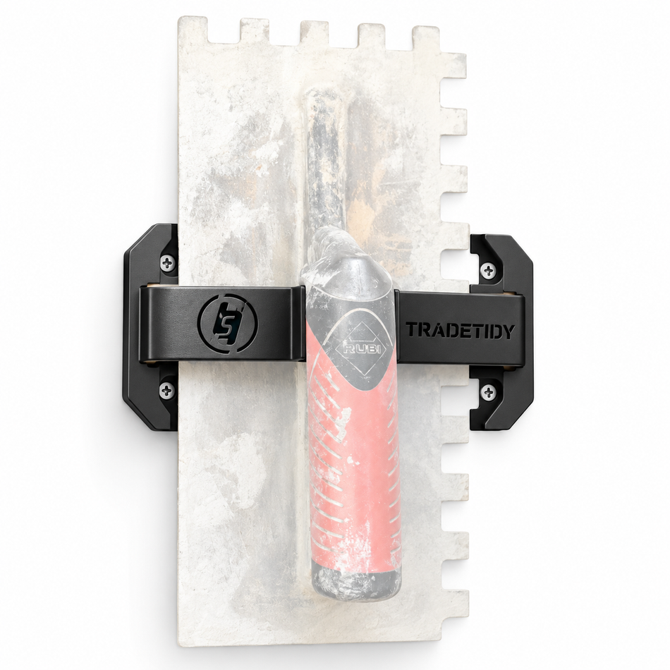 TradeTidy black Trowel Holder (pair) clamped onto a plastering trowel - wall-mounted steel trowel bracket for plasterers and tilers