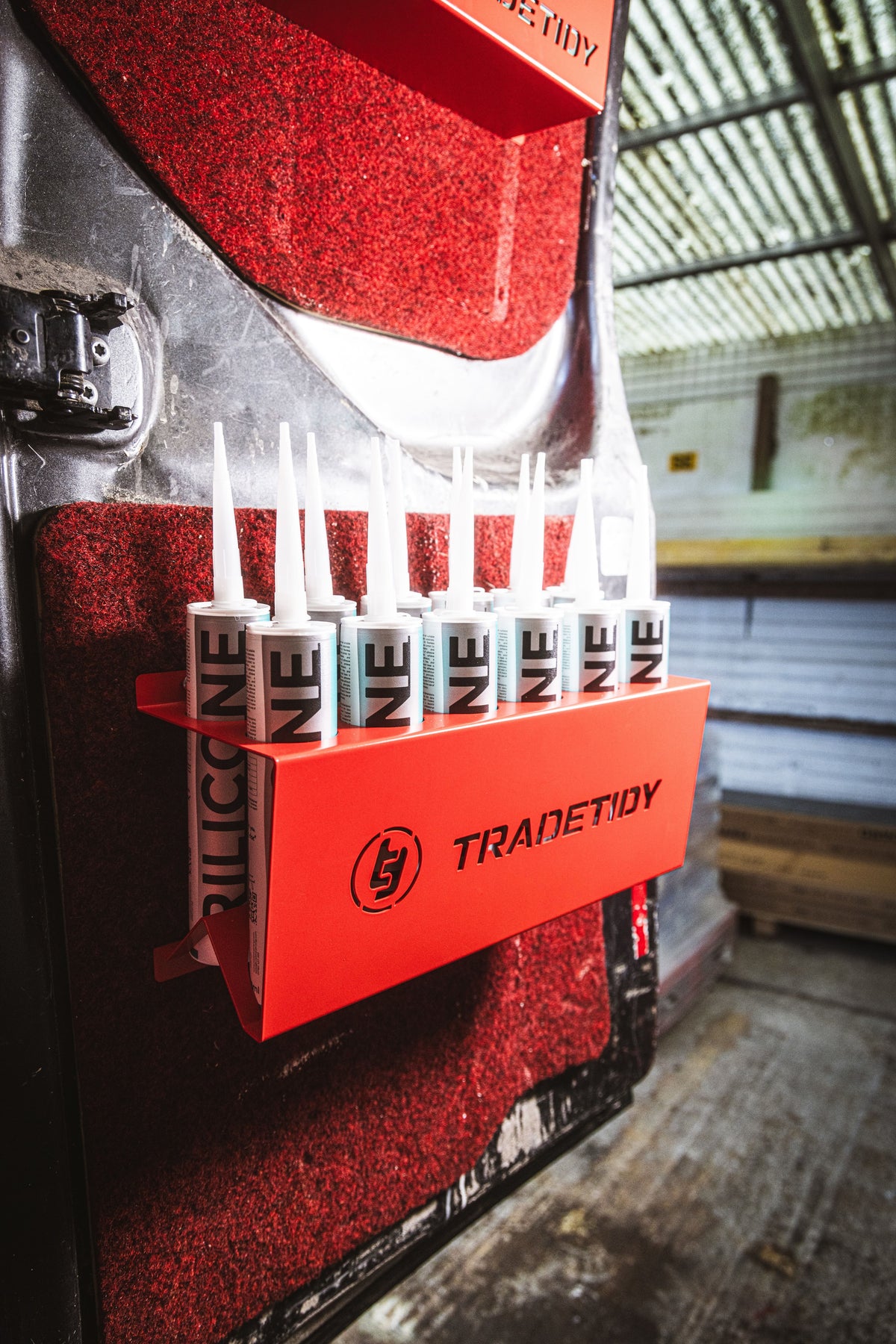 TradeTidy - silicone tubes in a red silicone tube holder hanging on a workshop van's door