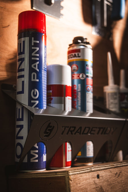 TradeTidy - Spray Cans in a Black Can Holder mounted on a Wooden Wall