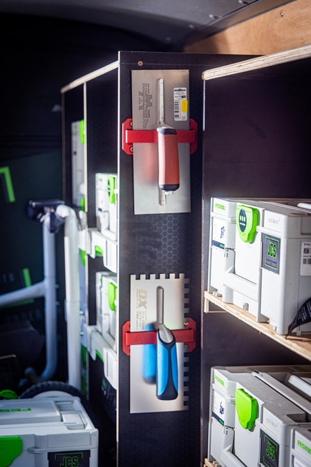 TradeTidy - Tool organizer with various tools on a wall-mounted panel showing trowels organised