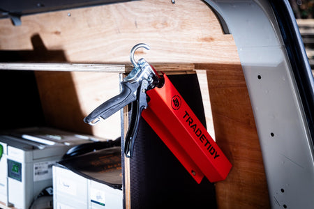 TradeTidy - silicone gun in a red silicone holder mounted on a workshop van