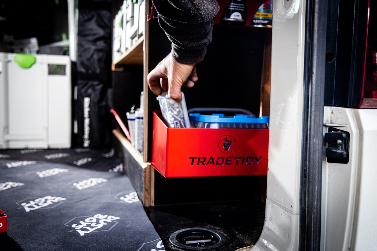 TradeTidy - Hand holding a tool in a red Storage Tray Mounted on a Wall.