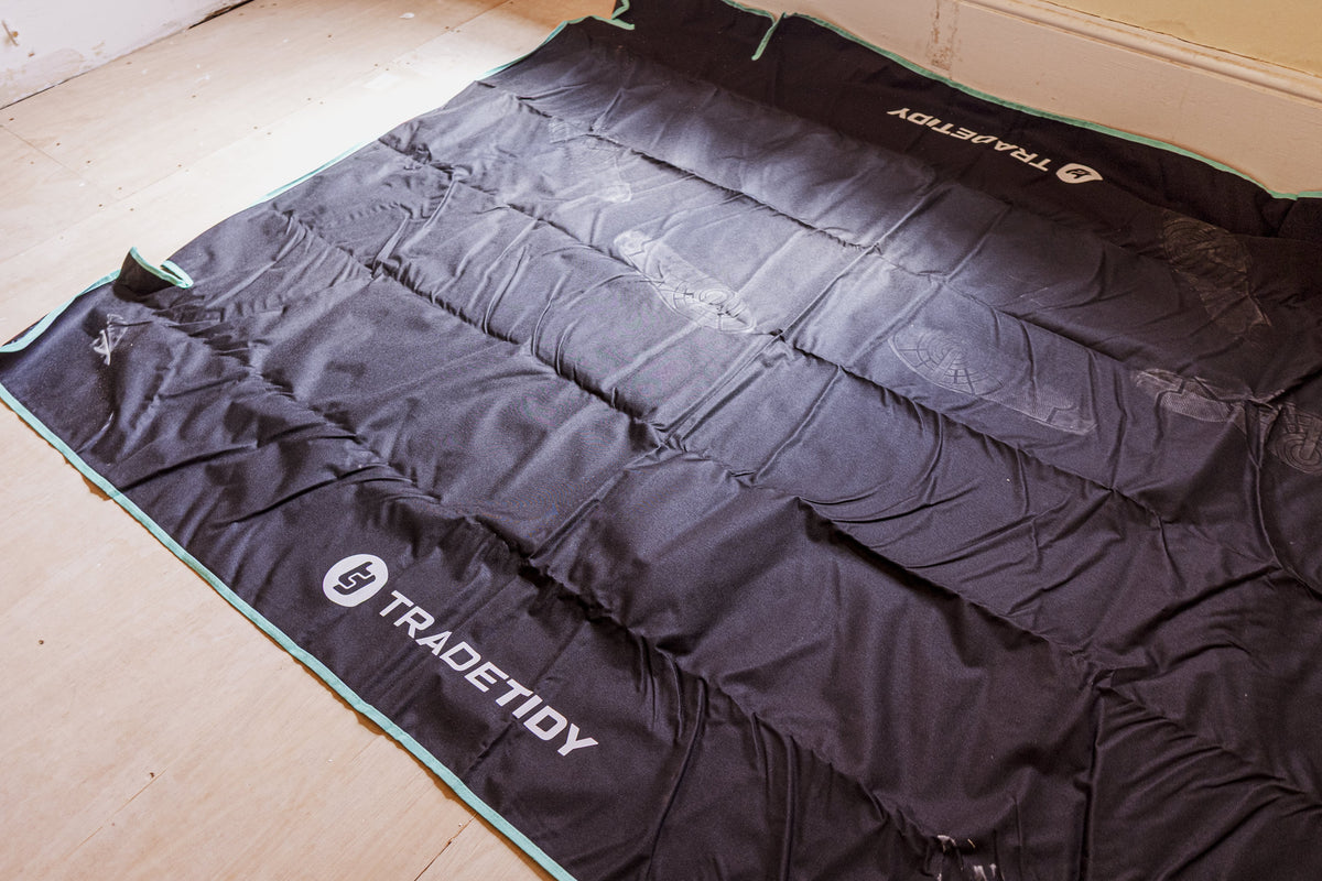 Black work bag with 'TradeTidy' branding on a wooden floor.