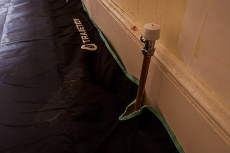 TradeTidy - Close-up of a black work bag with a brand logo on a wooden floor.