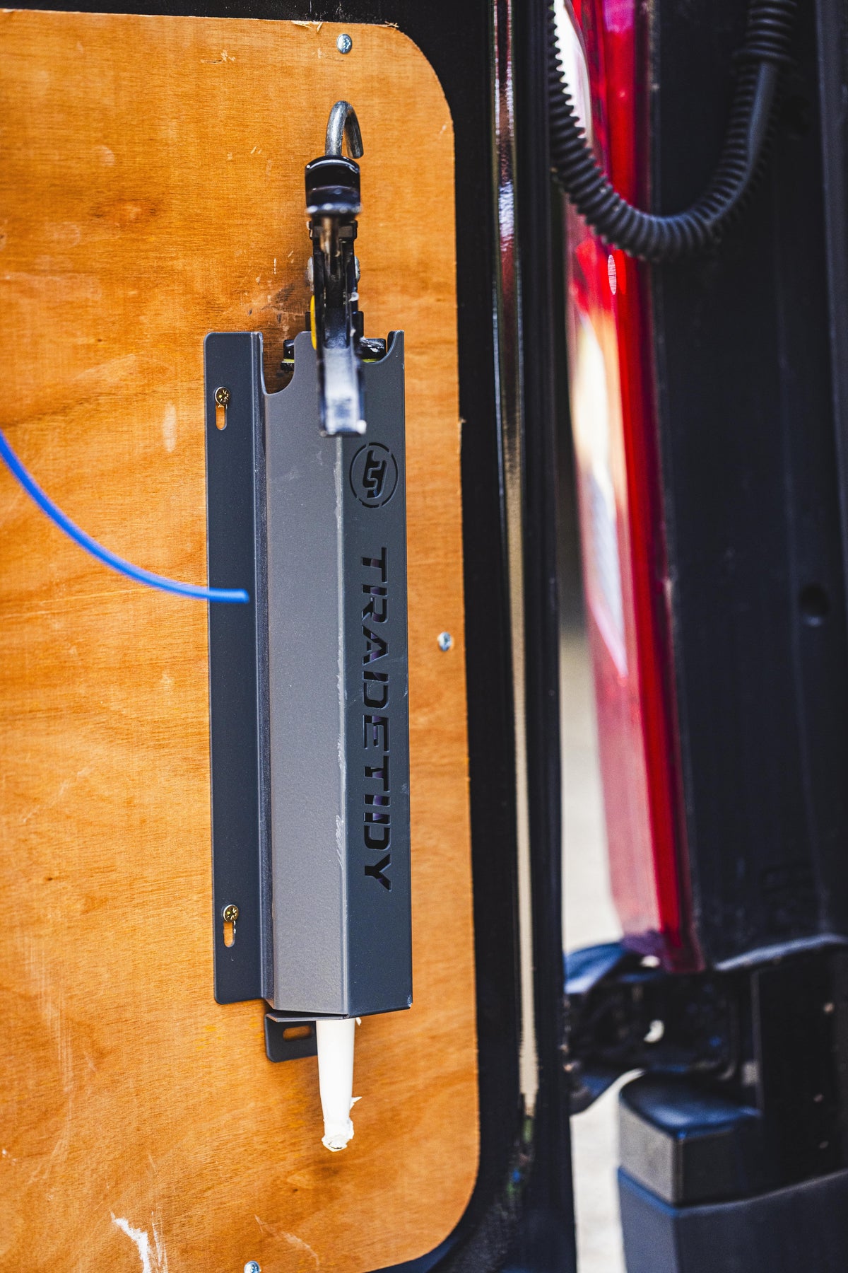 TradeTidy - silicone gun in a black silicone holder mounted on a workshop van