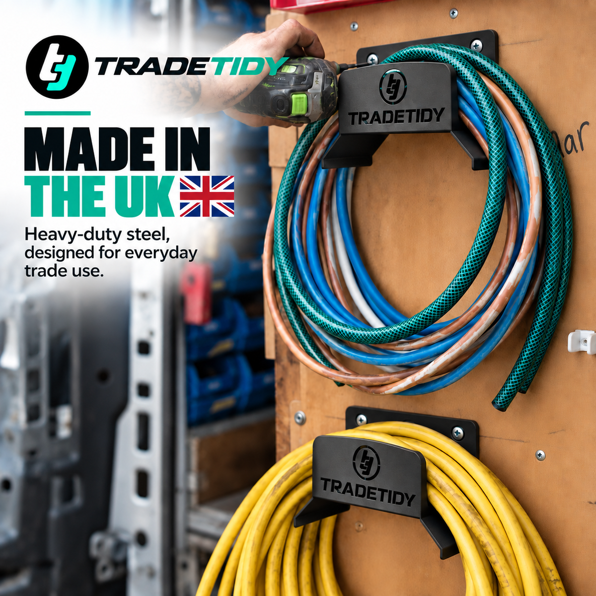 Made in the UK - two TradeTidy black Hose Holders mounted on a van wall holding coiled hoses and a yellow cable