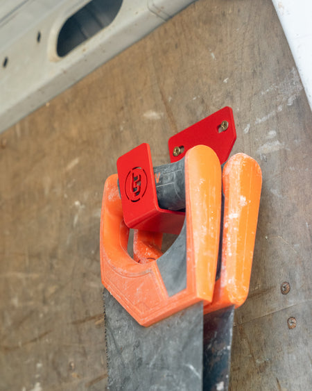 TradeTidy - Saw hanging on a red general purpose hook mounted on a workshop van