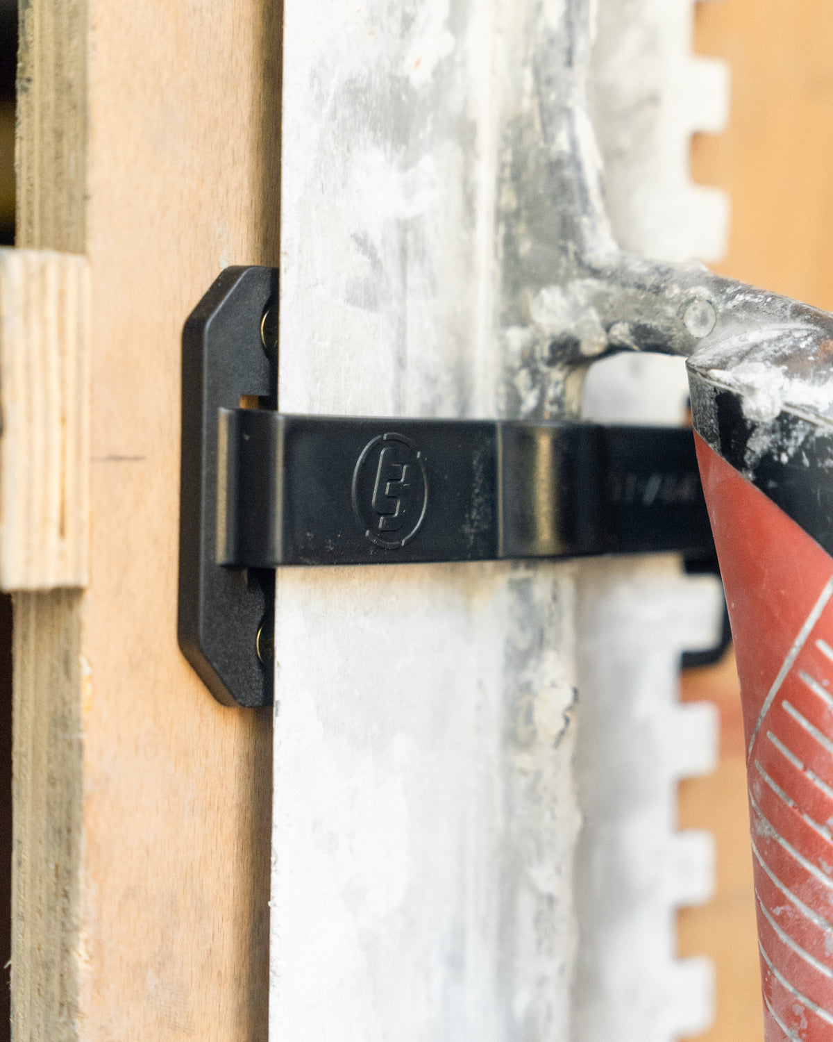 trowel in a trowel TradeTidy holder mounted on a wooden wall (view 2)