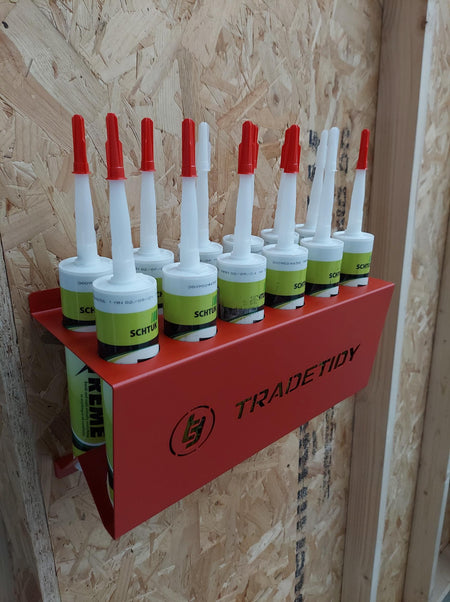 TradeTidy - silicone tubes in a red silicone tube holder hanging on a wooden wall