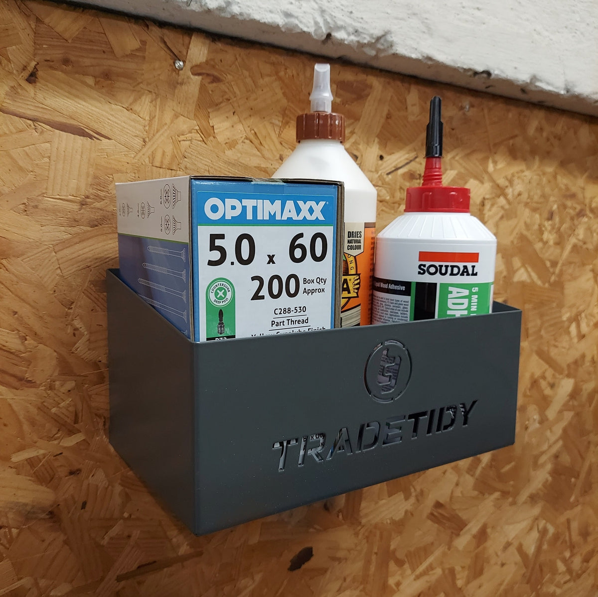 TradeTidy - Bottles in a grey Storage Tray Mounted on a Wooden Wall.