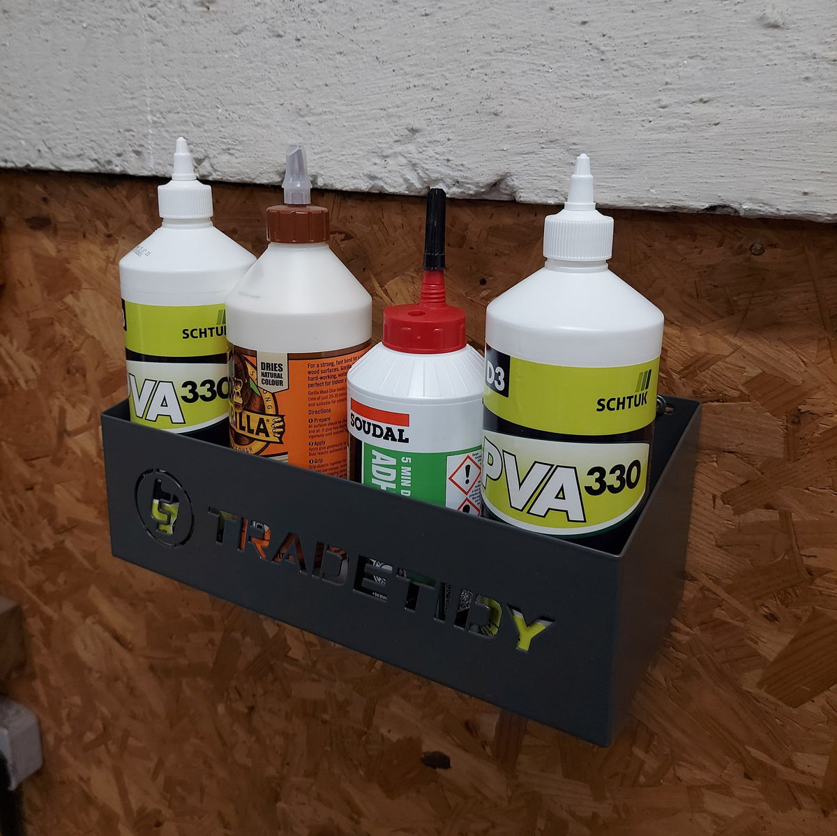 TradeTidy - Bottles in a grey Storage Tray Mounted on a Wooden Wall.