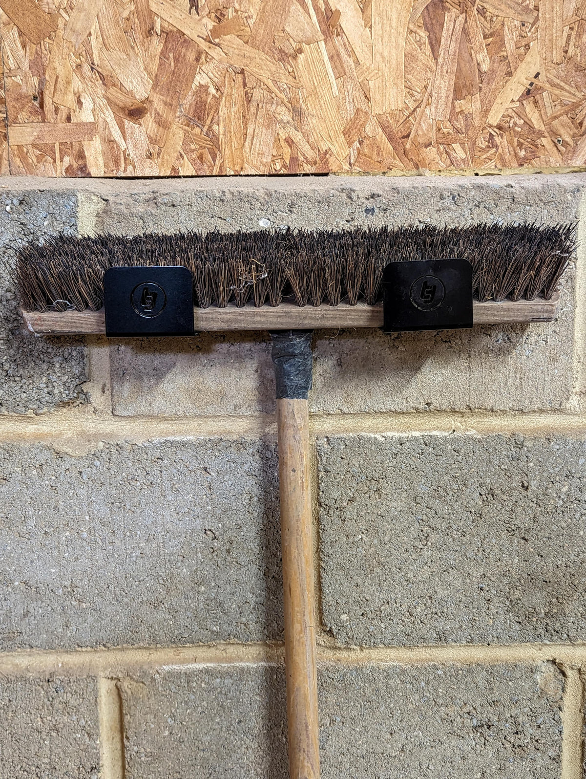 TradeTidy - Broom mounted in a Black Broom Holder Brackets