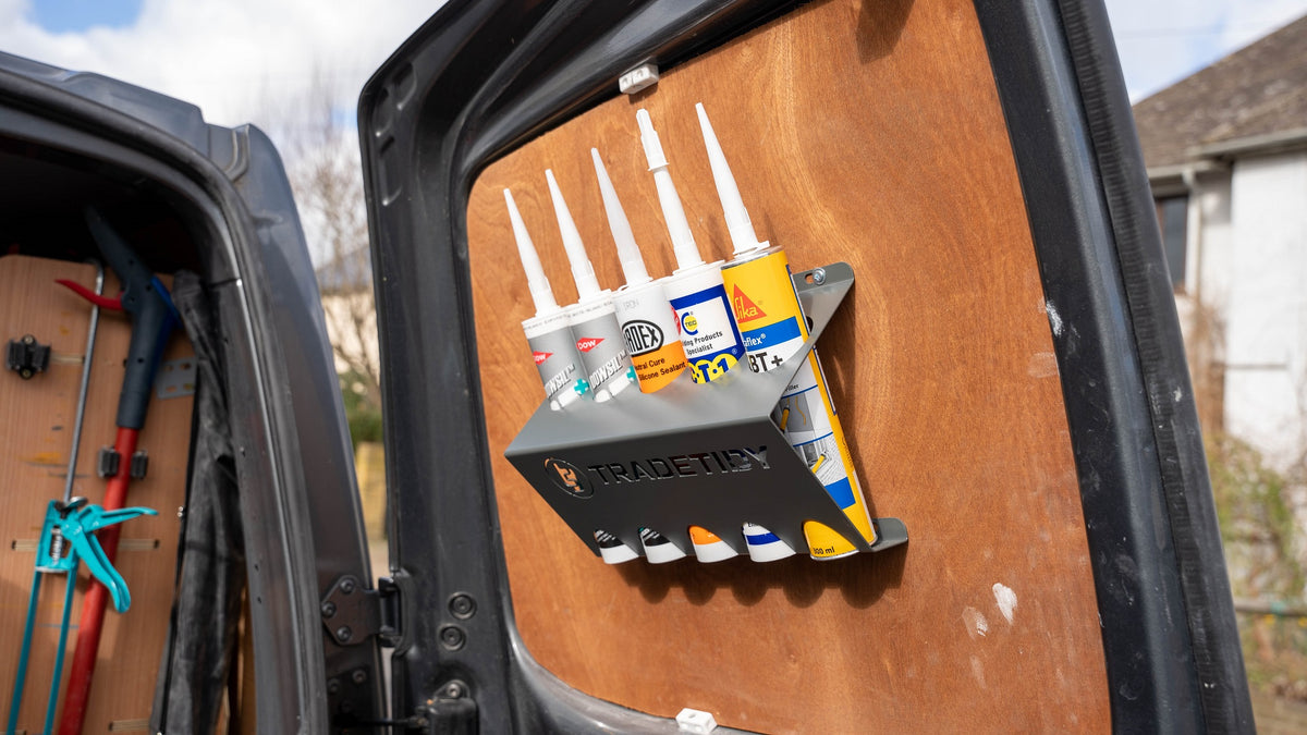 TradeTidy - Five Silicone Tubes in a Black Mastic & Silicone Tube Holder Installed on a Workshop Van's Door