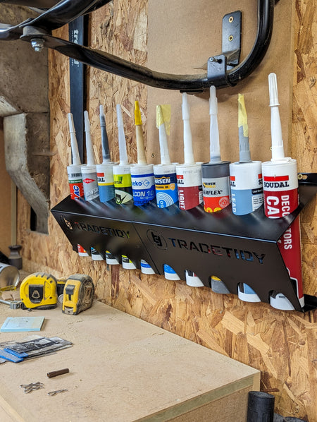 TradeTidy - Ten Silicone Tubes in 2 Black Mastic & Silicone Tube Holders Installed on a Workshop Van's Wooden Wall